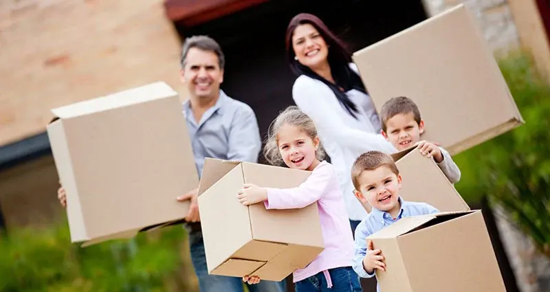 A family getting Onell Removals; Man & Van and Deliveries’ domestic service and carrying moving boxes